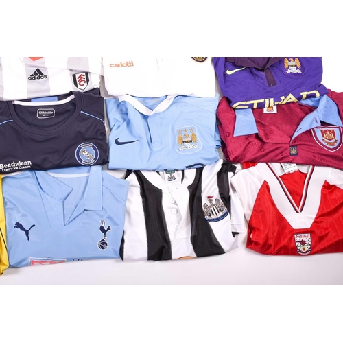 519 - A large collection of official club football shirts, polo shirts and jackets, adult sizes from vario... 