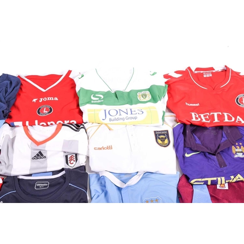 519 - A large collection of official club football shirts, polo shirts and jackets, adult sizes from vario... 