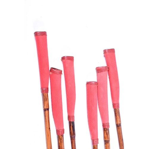 521 - A set of six polo mallets, with bamboo shafts, the head stamped for the Mallet MFG Co, England, disp... 