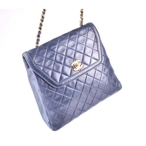 524 - Chanel. A classic quilted leather handbag, of tapered square design, with gold tone CC logo clasp, a... 