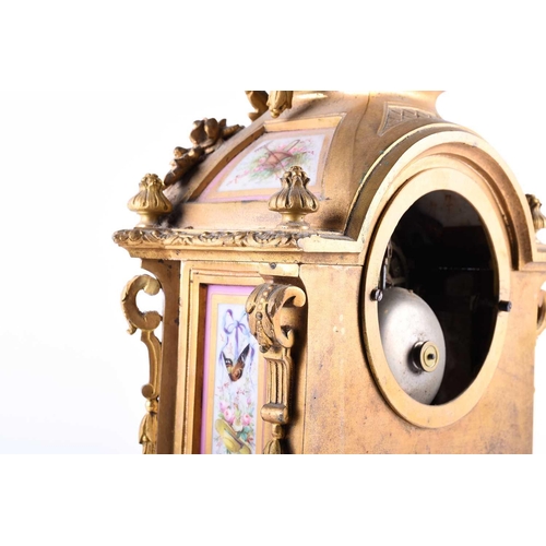 528 - A 19th century French ormolu mantel clock, surmounted by a vase with bellflower swags and lion masks... 