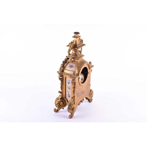 528 - A 19th century French ormolu mantel clock, surmounted by a vase with bellflower swags and lion masks... 