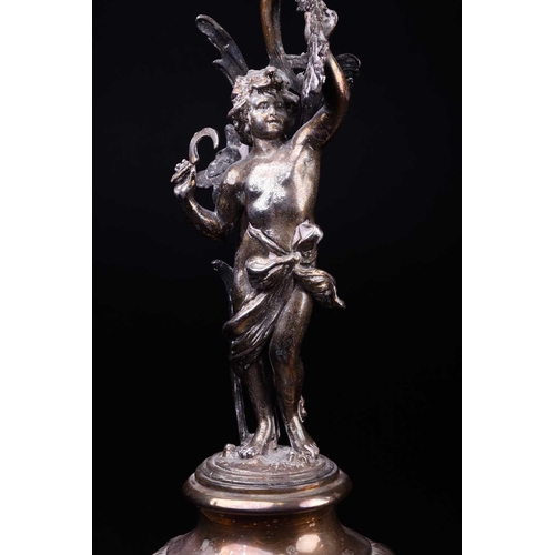 545 - A pair of Continental white metal candlesticks, late 19th century, modelled as a cherub with sickle ... 