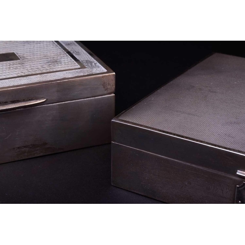 549 - Two silver cigarette boxes, 20th century, both with engine turned decoration, the larger example wit... 