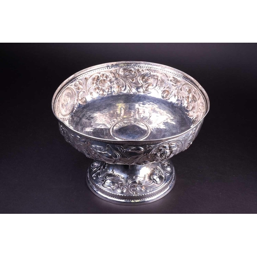 555 - A 19th century German silver centerpiece/fruit bowl, with repoussé foliate decoration on a circular ... 