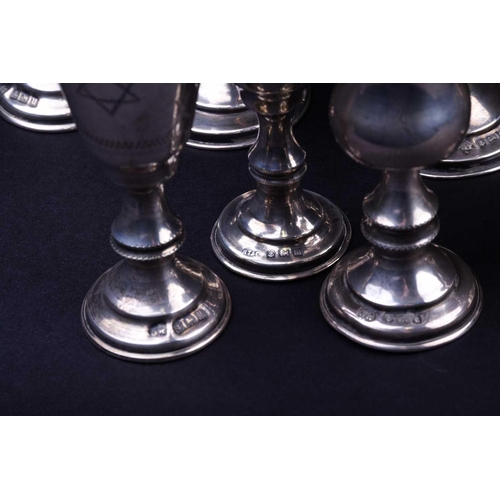 559 - A set of three silver tots, 8.4 cm high, together with two similar pairs, the largest 11 cm, various... 