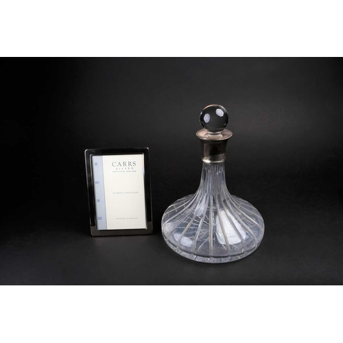 564 - A late 20th century glass decanter with silver collar, 26 cm high, together with a boxed Carrs silve... 