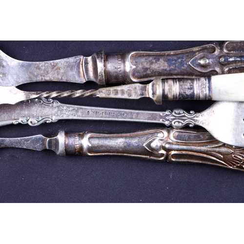 568 - A group of silver-handled flatware, together with a Continental silver plated twin-handled cup.