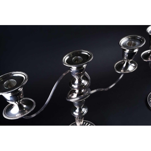 575 - A pair of large George III style silver plate on copper three branch candelabra, 20th century, 42cm