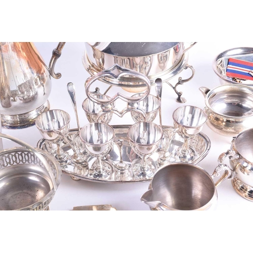 577 - A collection of silver plated items, to include a cocktail shaker, spirit kettle on stand, egg set o... 