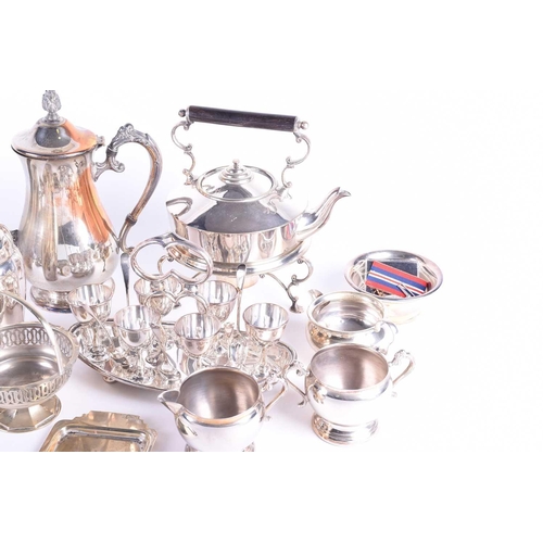 577 - A collection of silver plated items, to include a cocktail shaker, spirit kettle on stand, egg set o... 