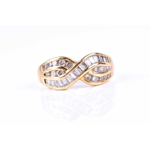 580 - A yellow metal and diamond crossover ring, channel-set with mixed baguette-cut and round-cut diamond... 