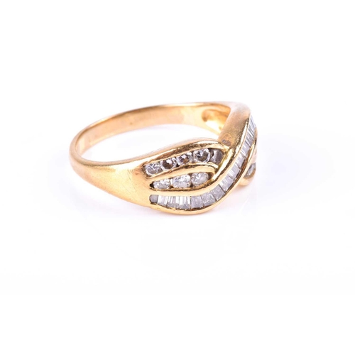 580 - A yellow metal and diamond crossover ring, channel-set with mixed baguette-cut and round-cut diamond... 