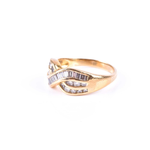 580 - A yellow metal and diamond crossover ring, channel-set with mixed baguette-cut and round-cut diamond... 