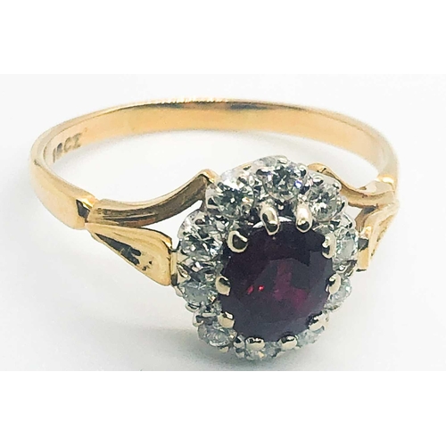 581A - An 18ct yellow gold, diamond, and ruby cluster ring, set with a mixed oval-cut ruby, within a border... 