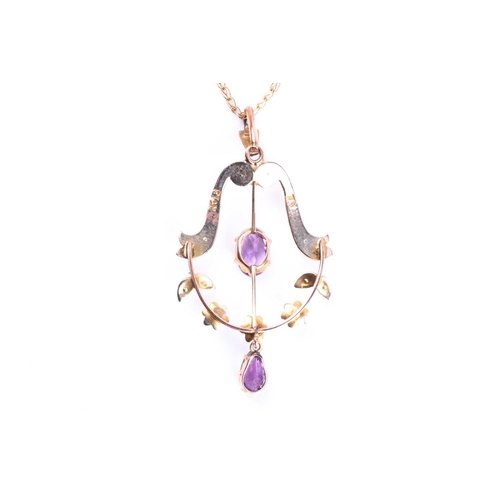 583 - An Edwardian amethyst and seed pearl negligee pendant, the principle oval cut amethyst within a seed... 