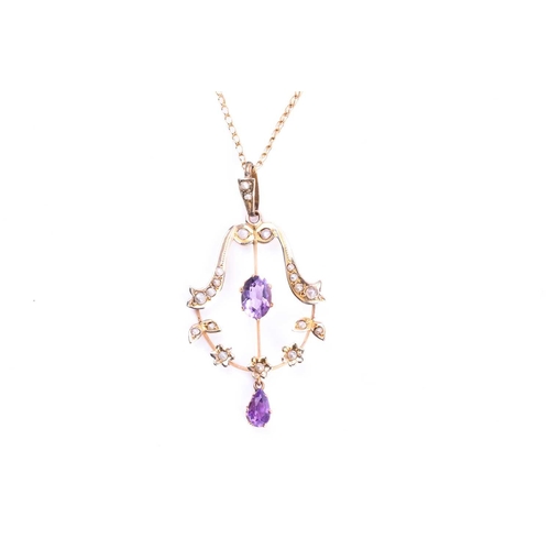 583 - An Edwardian amethyst and seed pearl negligee pendant, the principle oval cut amethyst within a seed... 