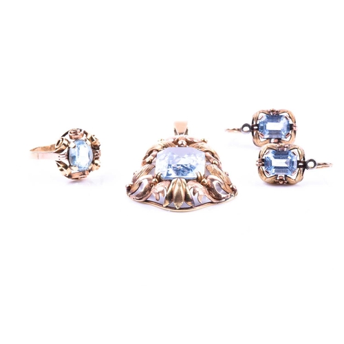 594 - A blue topaz dress suite, the pendant with a rectangular cut-cornered topaz in two colour pierced an... 