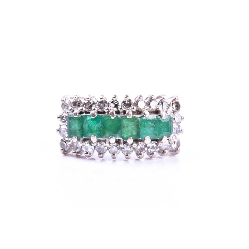 604 - A diamond and emerald ring, set with six mixed-cut emeralds within a border of round brilliant-cut d... 