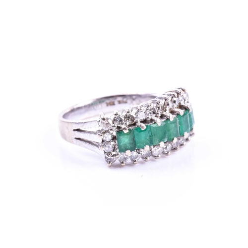 604 - A diamond and emerald ring, set with six mixed-cut emeralds within a border of round brilliant-cut d... 