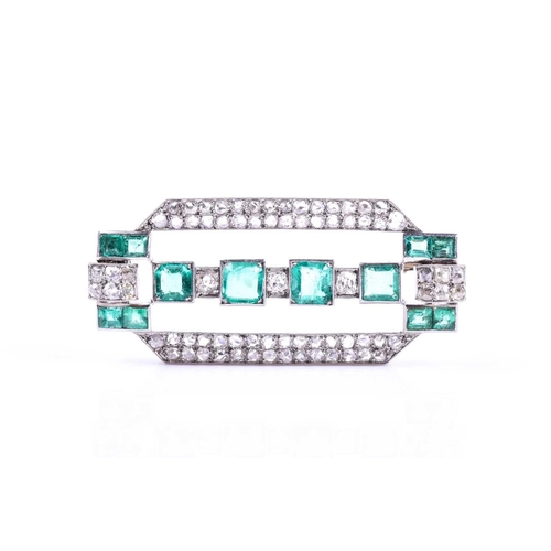 607 - An Art Deco diamond and emerald brooch the rectangular mount inset with twelve emeralds (likely of C... 