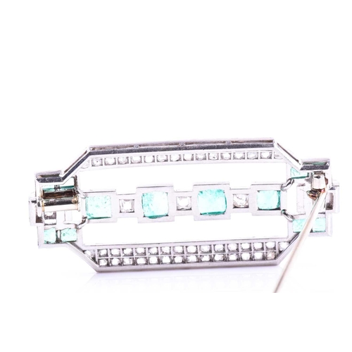 607 - An Art Deco diamond and emerald brooch the rectangular mount inset with twelve emeralds (likely of C... 