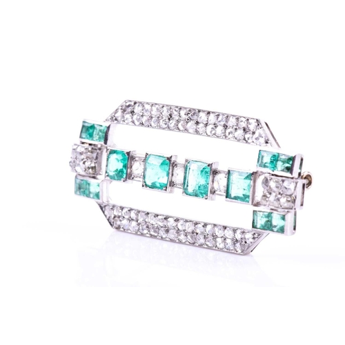 607 - An Art Deco diamond and emerald brooch the rectangular mount inset with twelve emeralds (likely of C... 