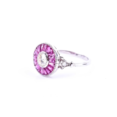 608 - A diamond and ruby target ring, in the Art Deco style, centred with a round brilliant-cut diamond, o... 