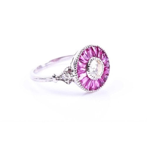 608 - A diamond and ruby target ring, in the Art Deco style, centred with a round brilliant-cut diamond, o... 