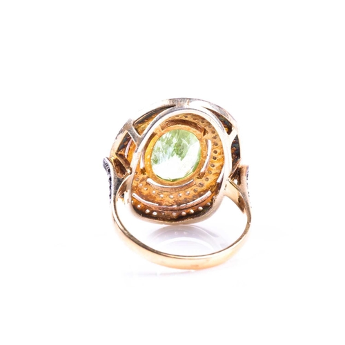 609 - A silver gilt, peridot, and diamond cocktail ring, the silver gilt mount set with a mixed oval-cut p... 