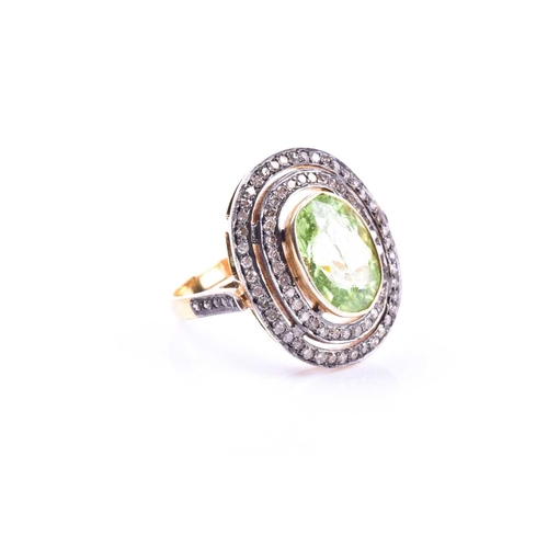 609 - A silver gilt, peridot, and diamond cocktail ring, the silver gilt mount set with a mixed oval-cut p... 