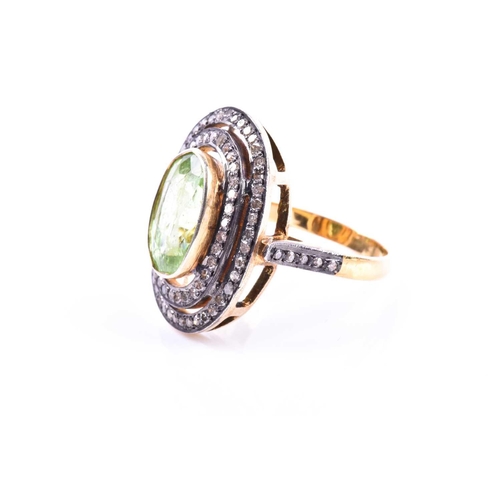 609 - A silver gilt, peridot, and diamond cocktail ring, the silver gilt mount set with a mixed oval-cut p... 