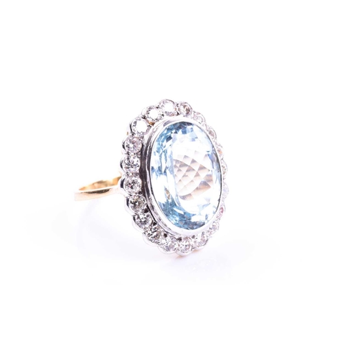 611 - An 18ct yellow gold, diamond, and aquamarine cocktail ring, set with a mixed oval-cut aquamarine of ... 