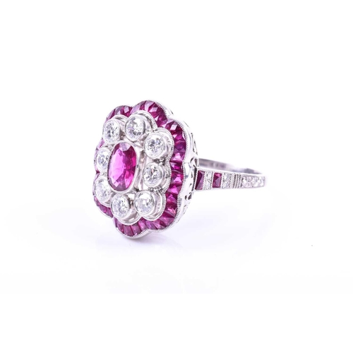 616 - An unusual platinum, diamond, and ruby cocktail ring, centred with a mixed oval-cut ruby, within a b... 