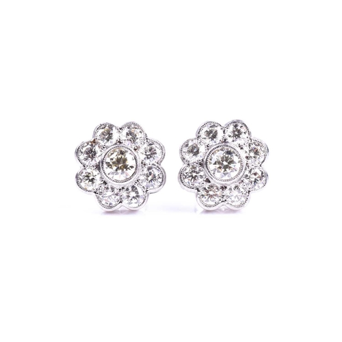 618 - A pair of diamond floral cluster earrings, set with round brilliant-cut diamonds of approximately 2.... 