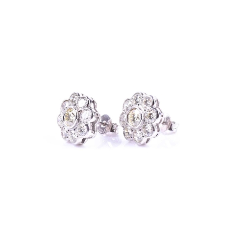 618 - A pair of diamond floral cluster earrings, set with round brilliant-cut diamonds of approximately 2.... 