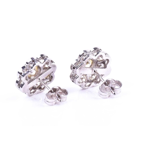 618 - A pair of diamond floral cluster earrings, set with round brilliant-cut diamonds of approximately 2.... 