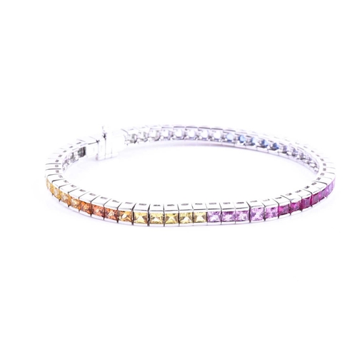 619 - An 18ct white gold and rainbow sapphire bracelet, set with multi-coloured sapphires ranging from gre... 