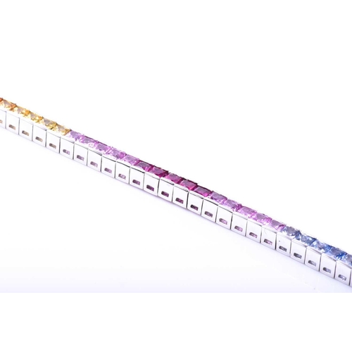 619 - An 18ct white gold and rainbow sapphire bracelet, set with multi-coloured sapphires ranging from gre... 