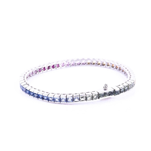 619 - An 18ct white gold and rainbow sapphire bracelet, set with multi-coloured sapphires ranging from gre... 