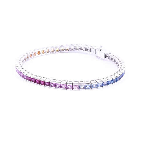 619 - An 18ct white gold and rainbow sapphire bracelet, set with multi-coloured sapphires ranging from gre... 