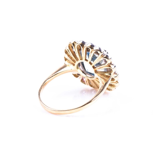 621 - An 18ct yellow gold, diamond, and aquamarine ring, set with a mixed cushion-cut aquamarine of approx... 