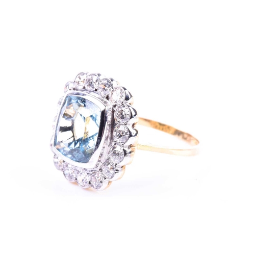 621 - An 18ct yellow gold, diamond, and aquamarine ring, set with a mixed cushion-cut aquamarine of approx... 