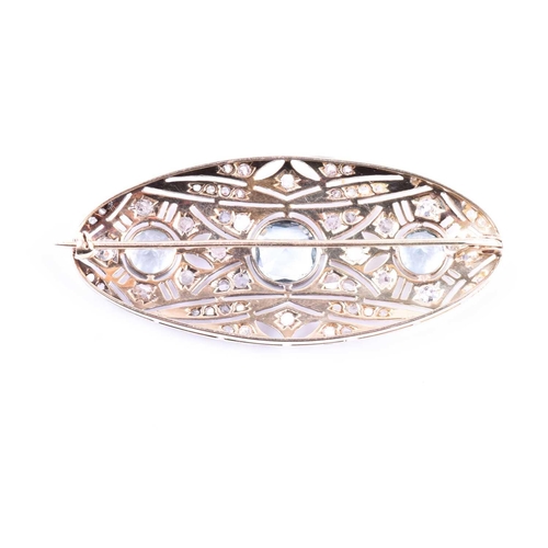 624 - An Art Deco diamond and aquamarine brooch of elongated oval form, the openwork mount set with rose-c... 