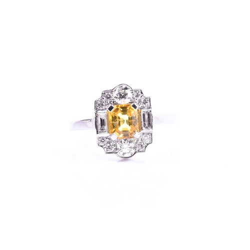 626 - A platinum, diamond, and yellow sapphire ring, in the Art Deco style, set with a mixed-cut sapphire ... 