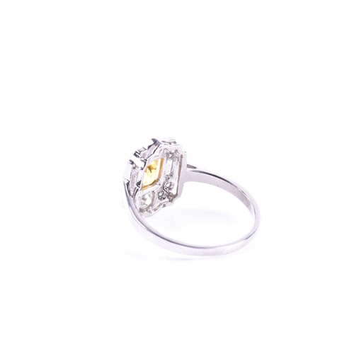 626 - A platinum, diamond, and yellow sapphire ring, in the Art Deco style, set with a mixed-cut sapphire ... 