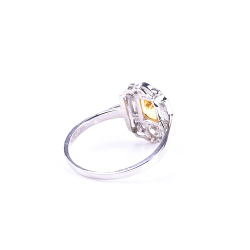 626 - A platinum, diamond, and yellow sapphire ring, in the Art Deco style, set with a mixed-cut sapphire ... 