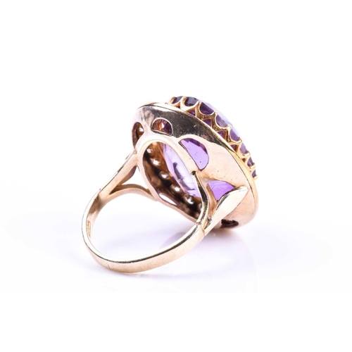 628 - A mid 20th century 18ct yellow gold, diamond, and amethyst cocktail ring, set with a mixed oval-cut ... 