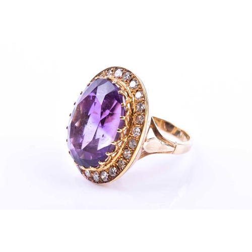 628 - A mid 20th century 18ct yellow gold, diamond, and amethyst cocktail ring, set with a mixed oval-cut ... 