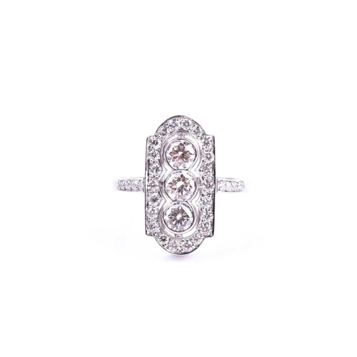 629 - A platinum and diamond ring, in the Art Deco style, the lozenge-shaped plaque ring inset with three ... 